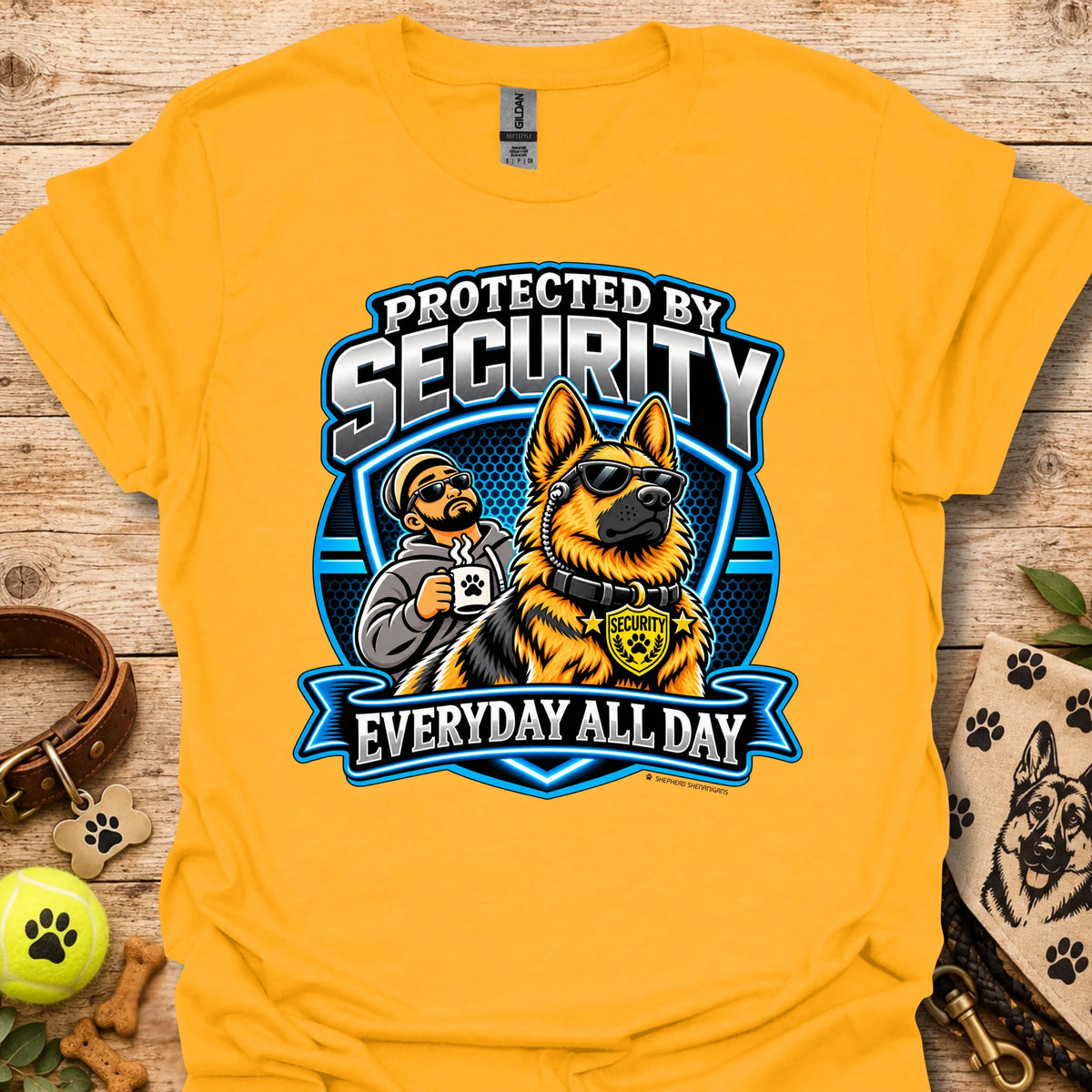 Gold T-shirt with a security guard and dog graphic and “Protected by Security” text