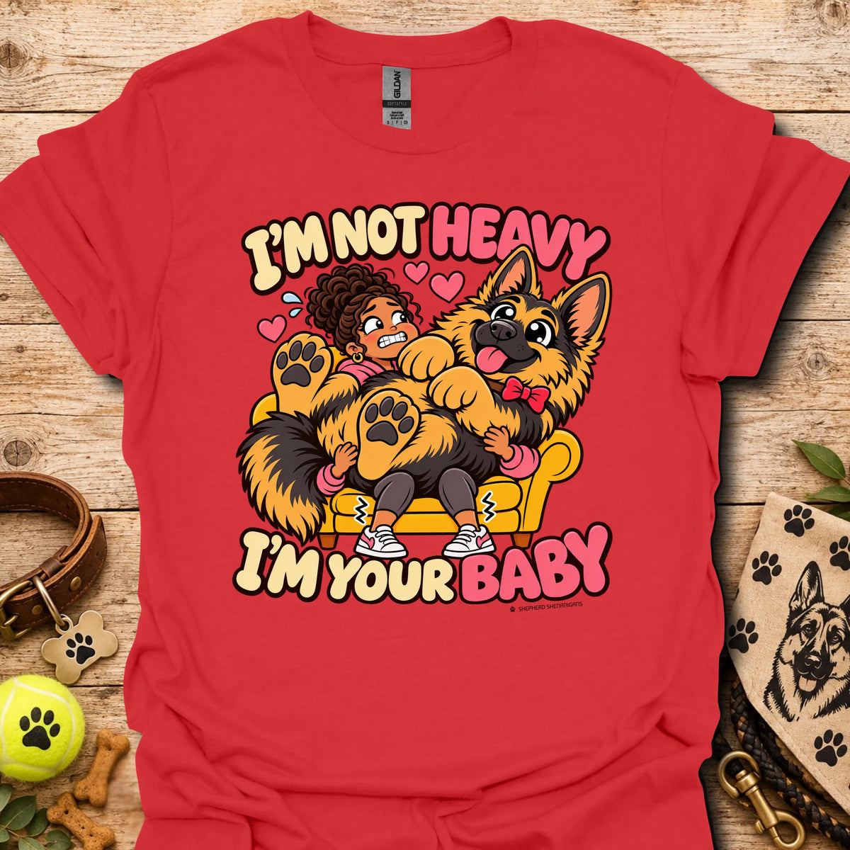Red T-shirt with a colorful child and dog graphic and “I'm Not Heavy I'm Your Baby” text