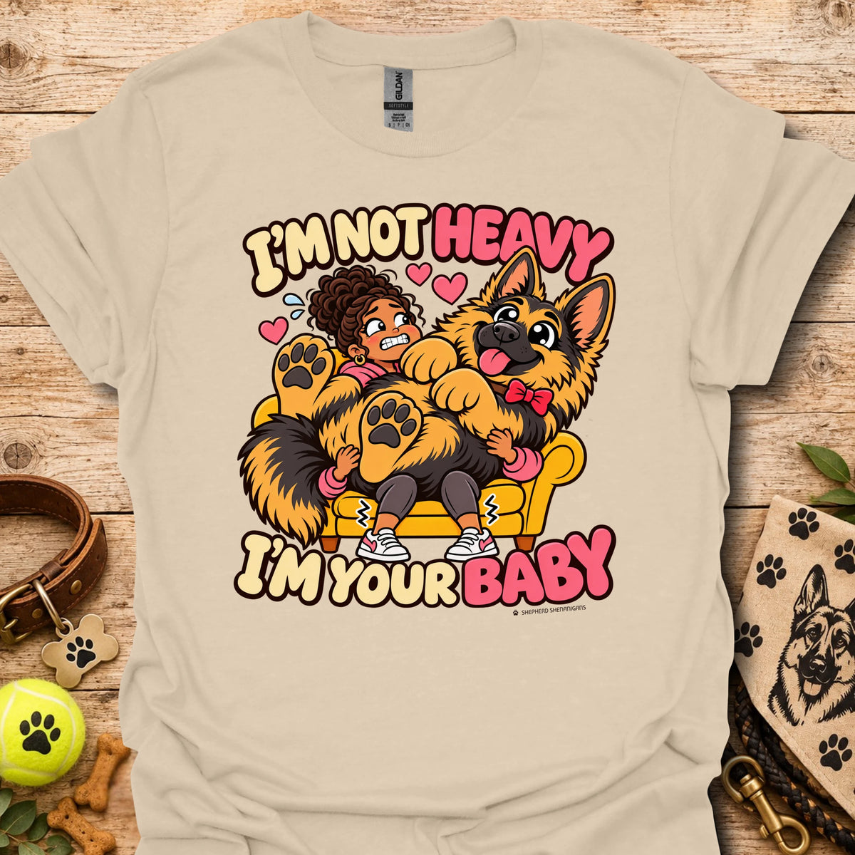 Sand T-shirt with a colorful child and dog graphic and “I'm Not Heavy I'm Your Baby” text