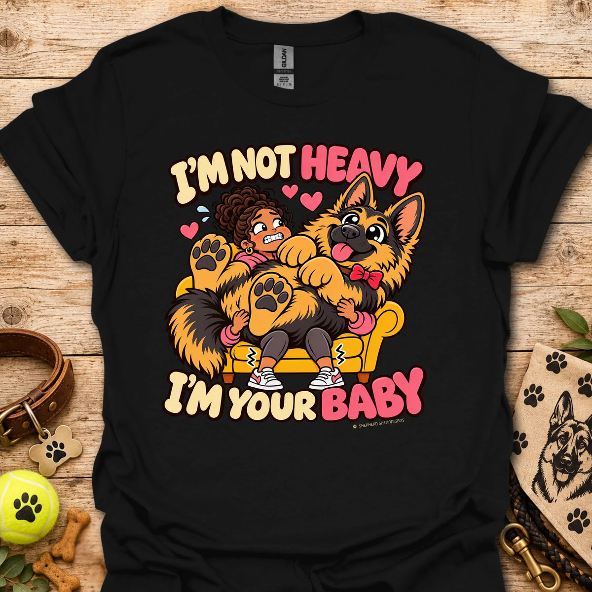 Black T-shirt with a colorful child and dog graphic and “I'm Not Heavy I'm Your Baby” text