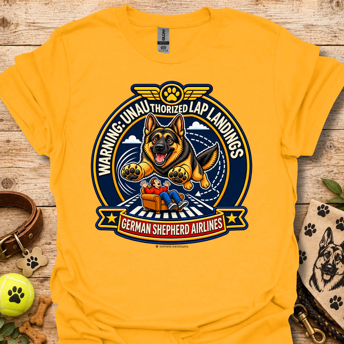Gold T-shirt with a German shepherd airline badge graphic and lap-landing warning