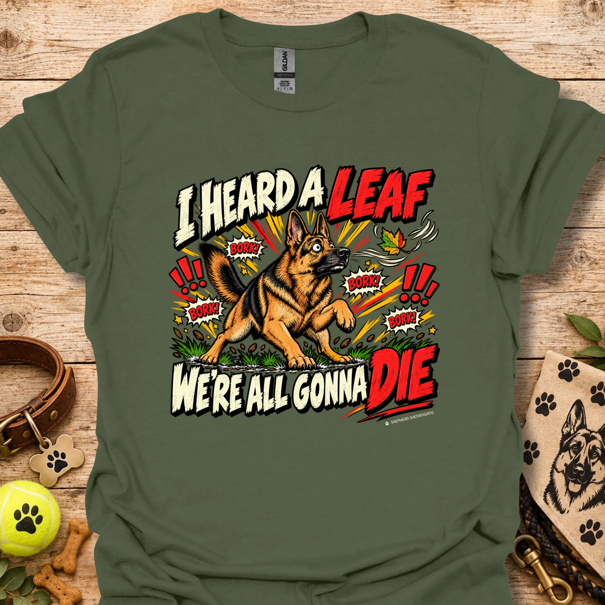 Olive green crew-neck T-shirt with colorful dog-and-leaf front graphic, short sleeves