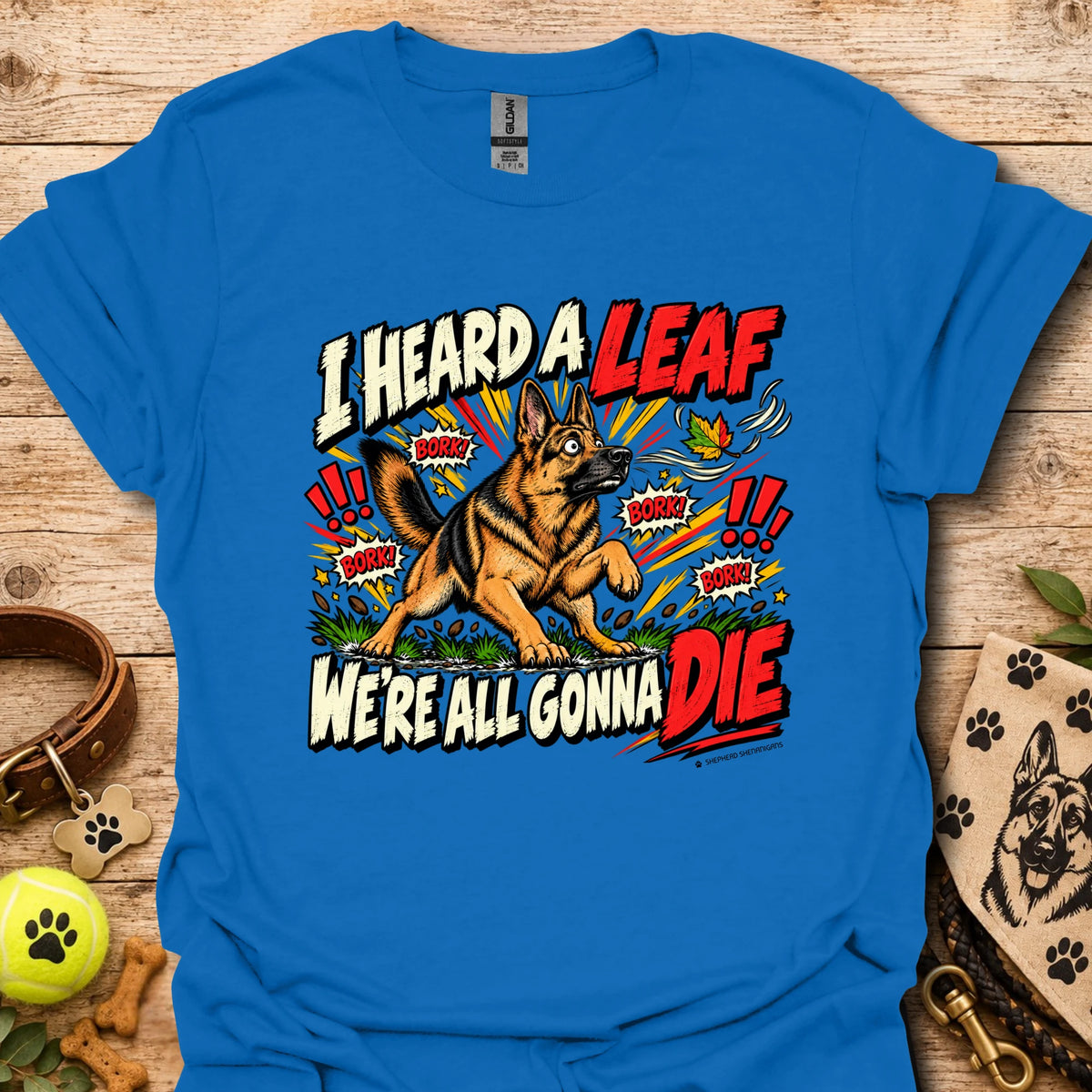 Bright blue crew-neck T-shirt with colorful dog-and-leaf front graphic, short sleeves
