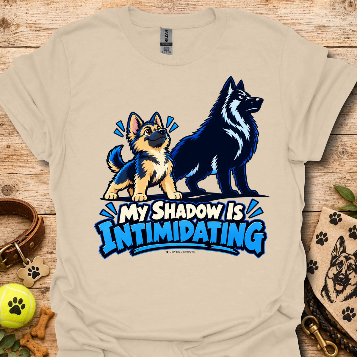 Sand/beige t-shirt with wolf dog graphic and blue “My Shadow Is Intimidating” text