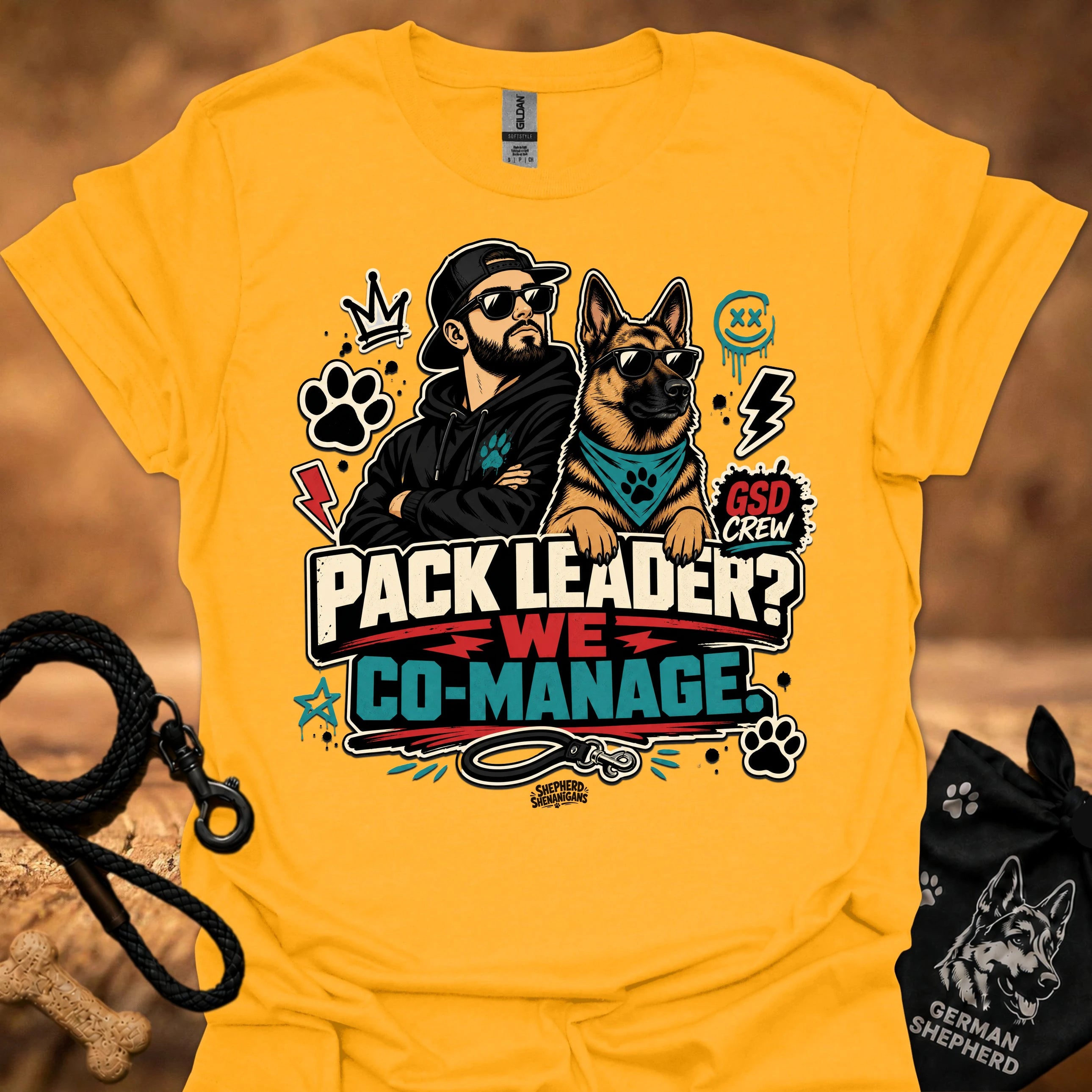 Gold crew-neck short-sleeve T-shirt with illustrated dog-and-man graphic and “Co-Manage” text
