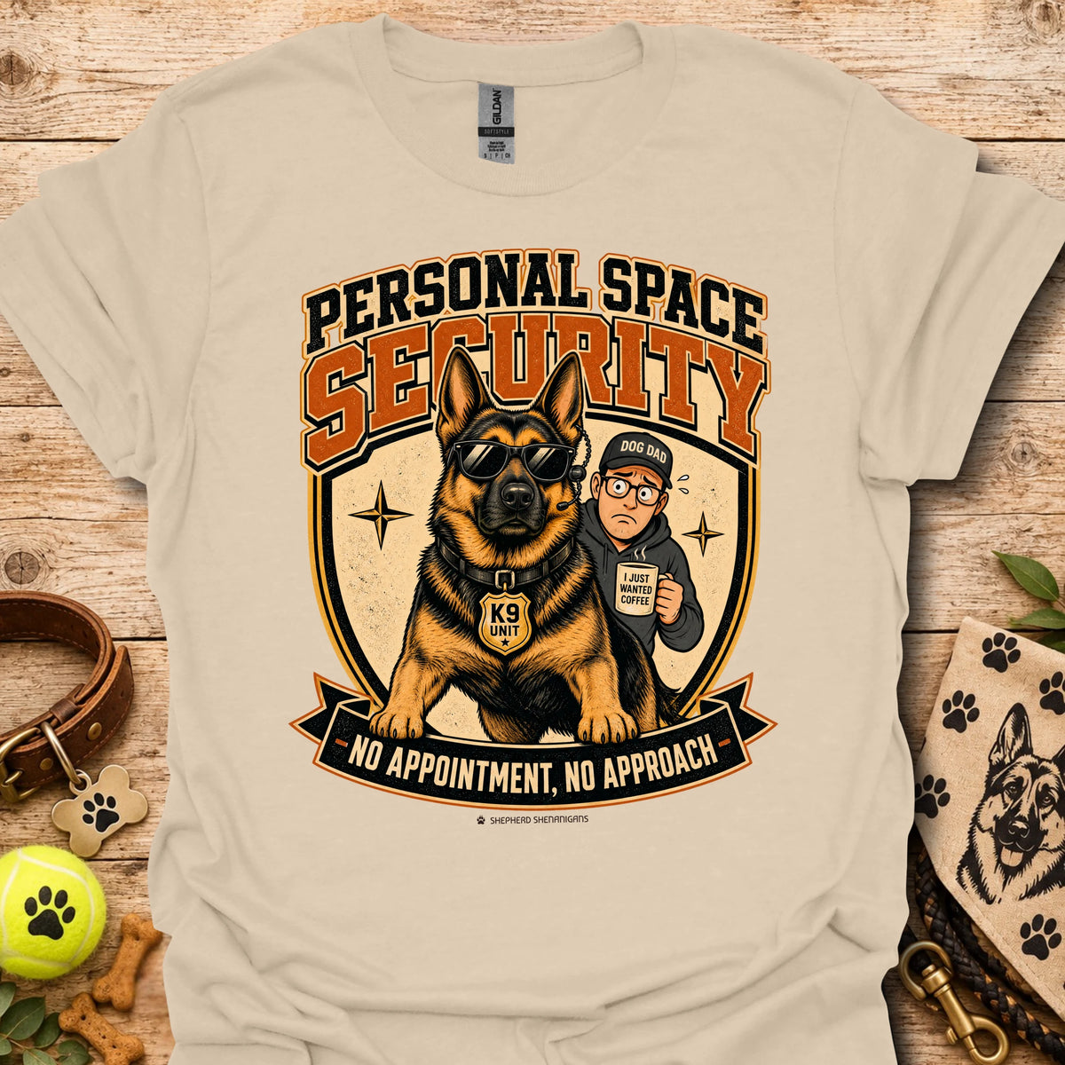 Sand T-shirt with a security dog and handler graphic and bold lettering.