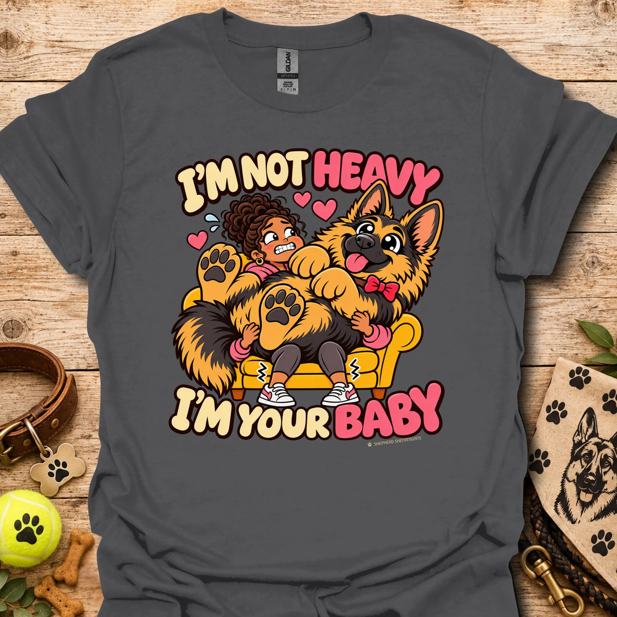Charcoal T-shirt with a colorful child and dog graphic and “I'm Not Heavy I'm Your Baby” text