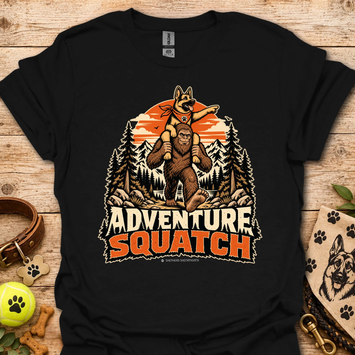 Black T-shirt with orange bear and pine tree logo graphic centered on the chest
