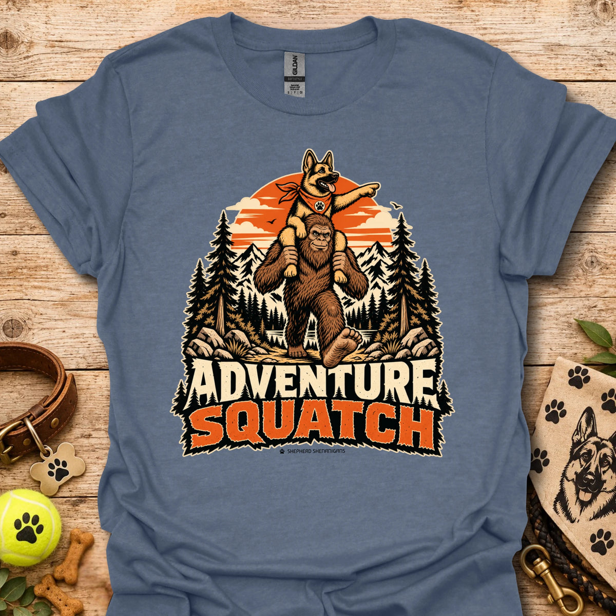 Blue T-shirt with orange bear and pine tree logo graphic centered on the chest