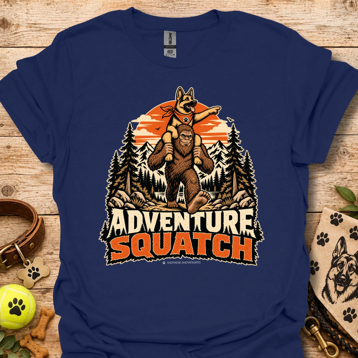 Navy T-shirt with orange bear and pine tree logo graphic centered on the chest