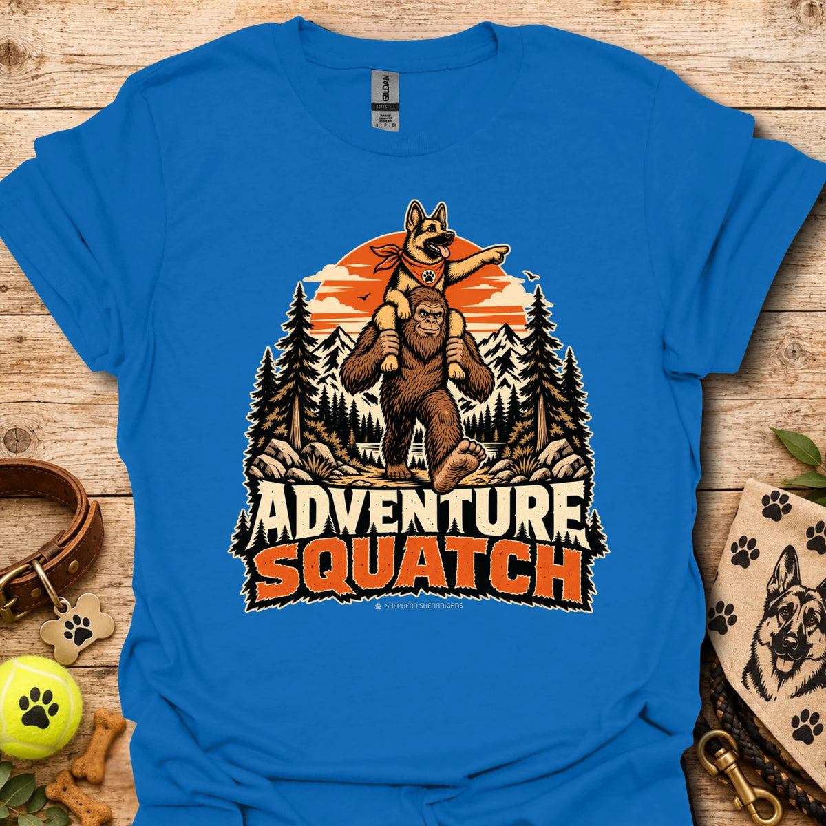Royal blue T-shirt with orange bear and pine tree logo graphic centered on the chest