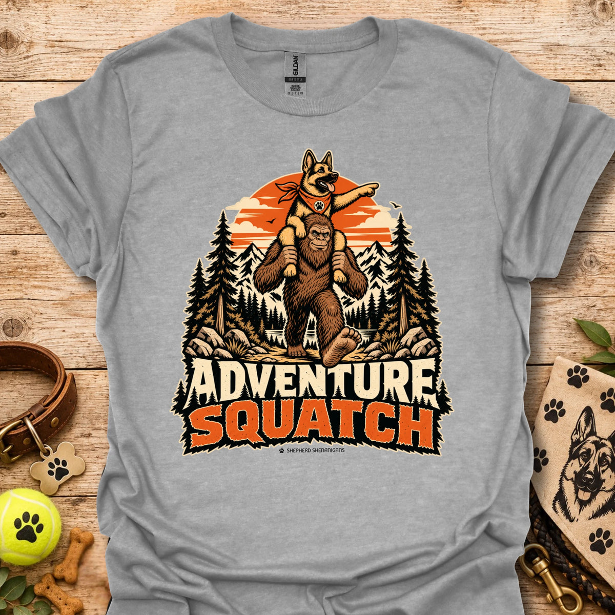 Gray T-shirt with orange bear and pine tree logo graphic centered on the chest