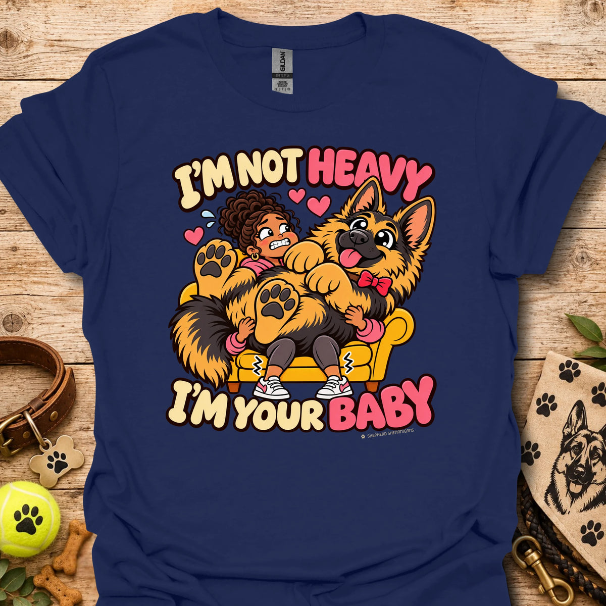 Navy T-shirt with a colorful child and dog graphic and “I'm Not Heavy I'm Your Baby” text