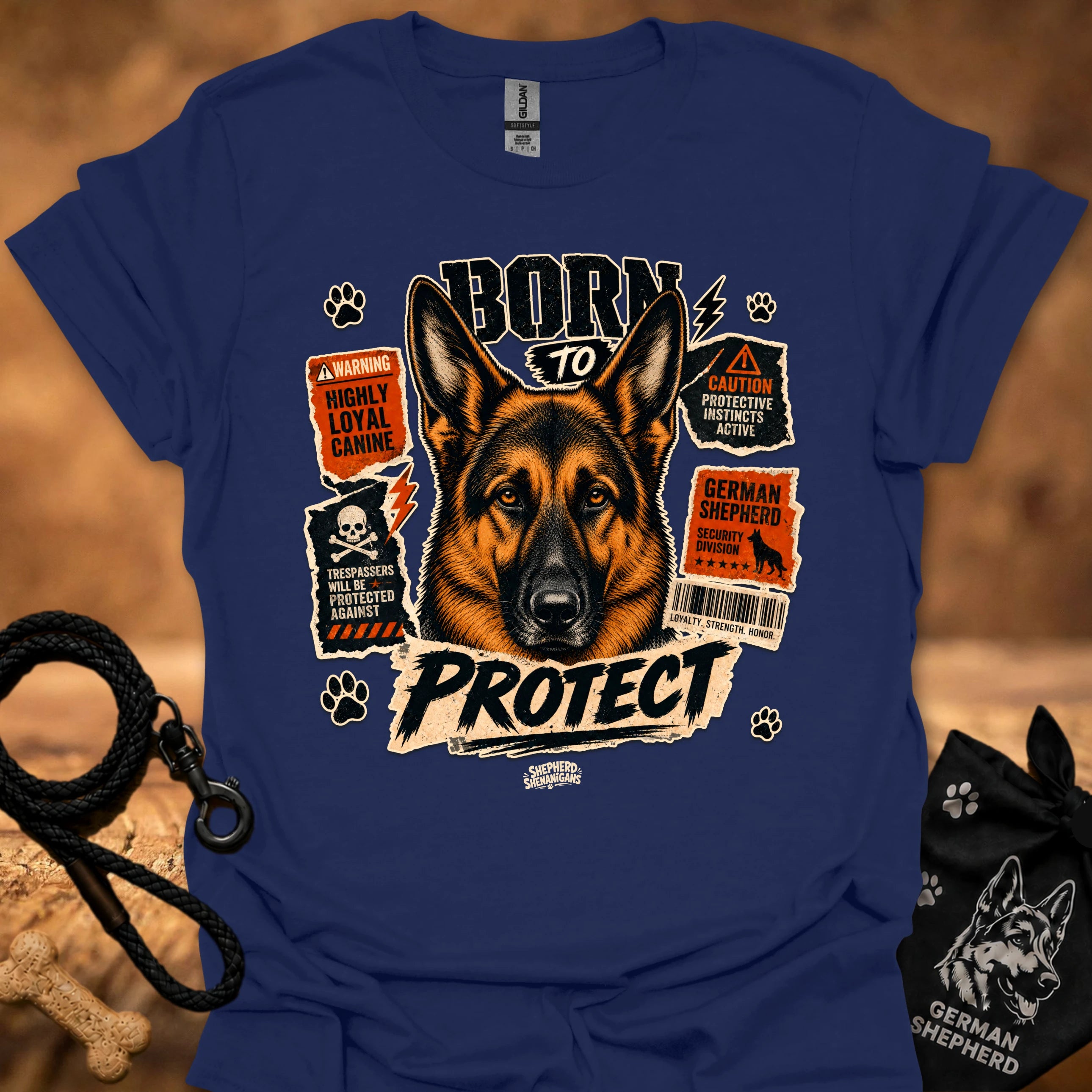 Blue graphic dog T-shirt with 'Born to Protect' text, paw prints, and warning labels