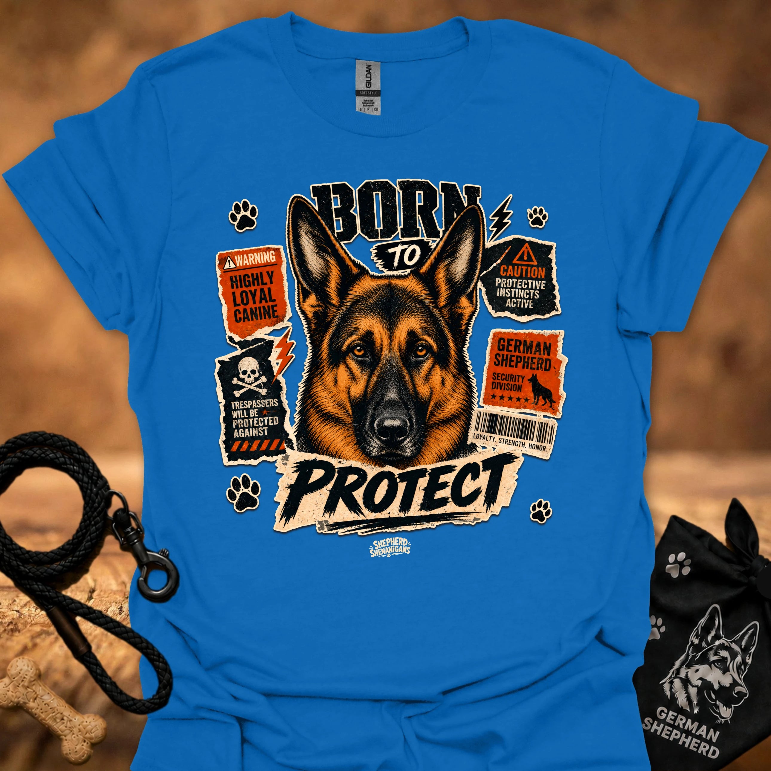 Blue graphic dog T-shirt featuring 'Born to Protect' text and warning label art
