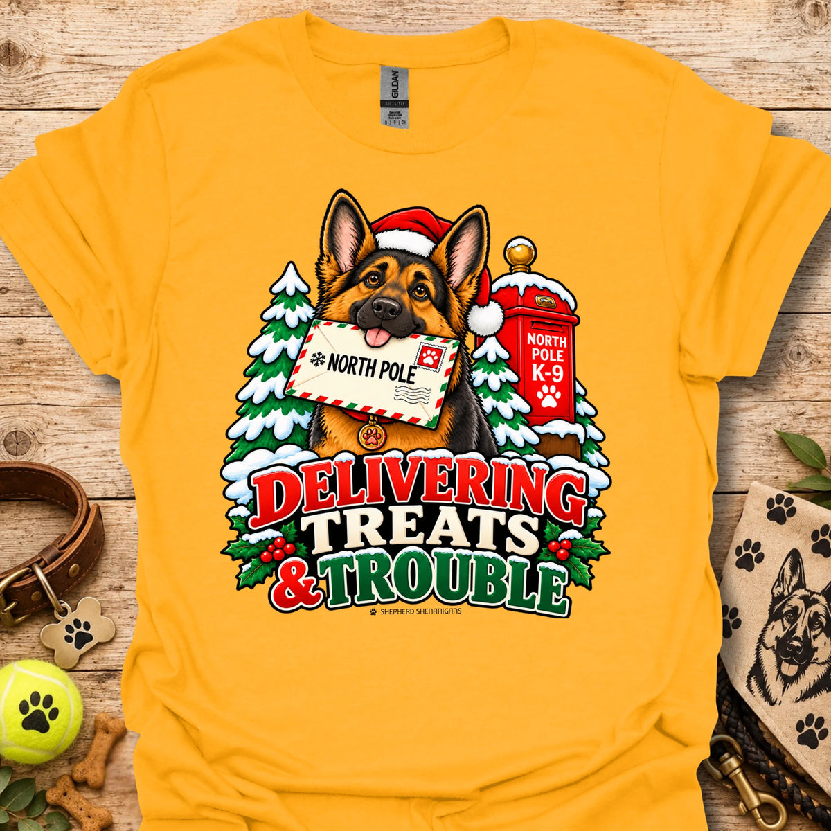 Gold T-shirt with colorful dog and holiday "Delivering Treats & Trouble" graphic