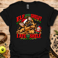 Black graphic t-shirt with cat-and-wood “Elf on the Shelf?” and “I ate the shelf” print