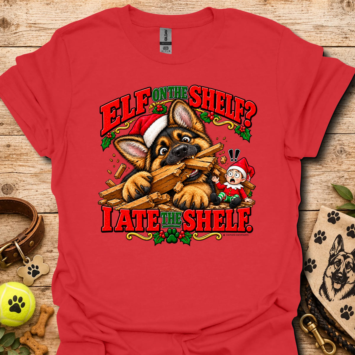 Red graphic t-shirt with cat-and-wood “Elf on the Shelf?” and “I ate the shelf” print