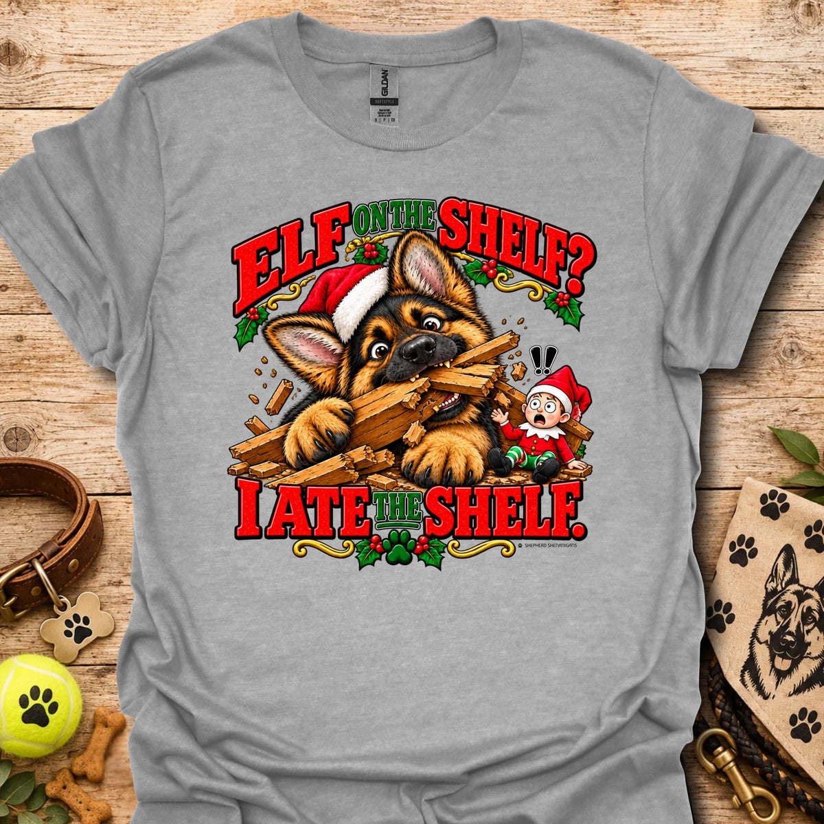 Heather gray graphic t-shirt with cat-and-wood “Elf on the Shelf?” and “I ate the shelf” print
