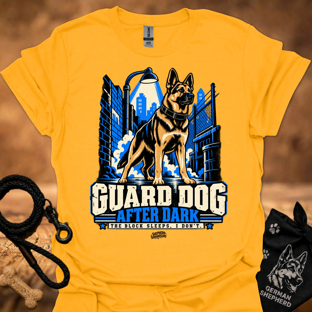 Gold T-shirt with “Guard Dog After Dark” graphic featuring German shepherd and city