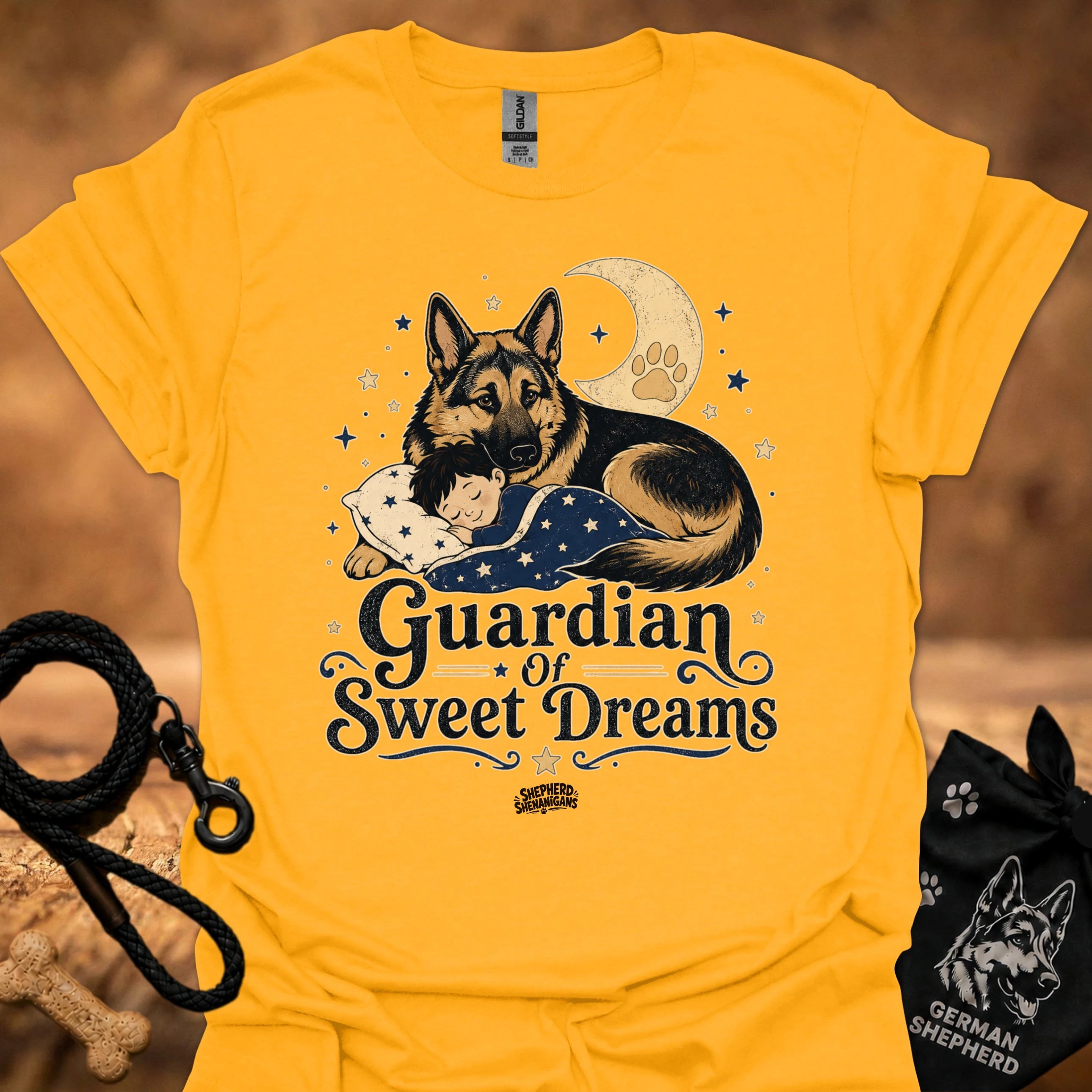 Gold T-shirt with front graphic of a German shepherd and sleeping child under moon