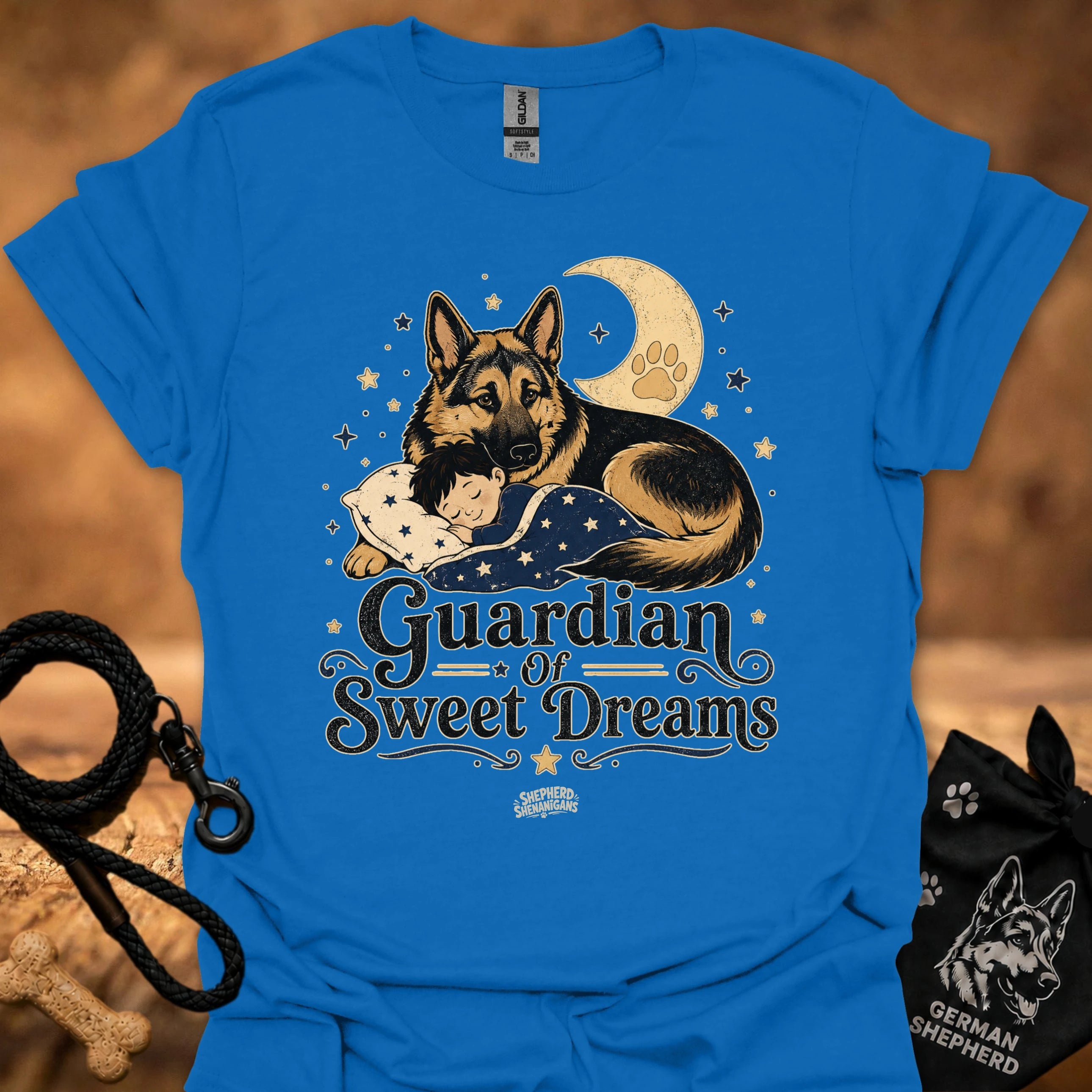 Royal blue T-shirt with front graphic of a German shepherd and sleeping child under moon