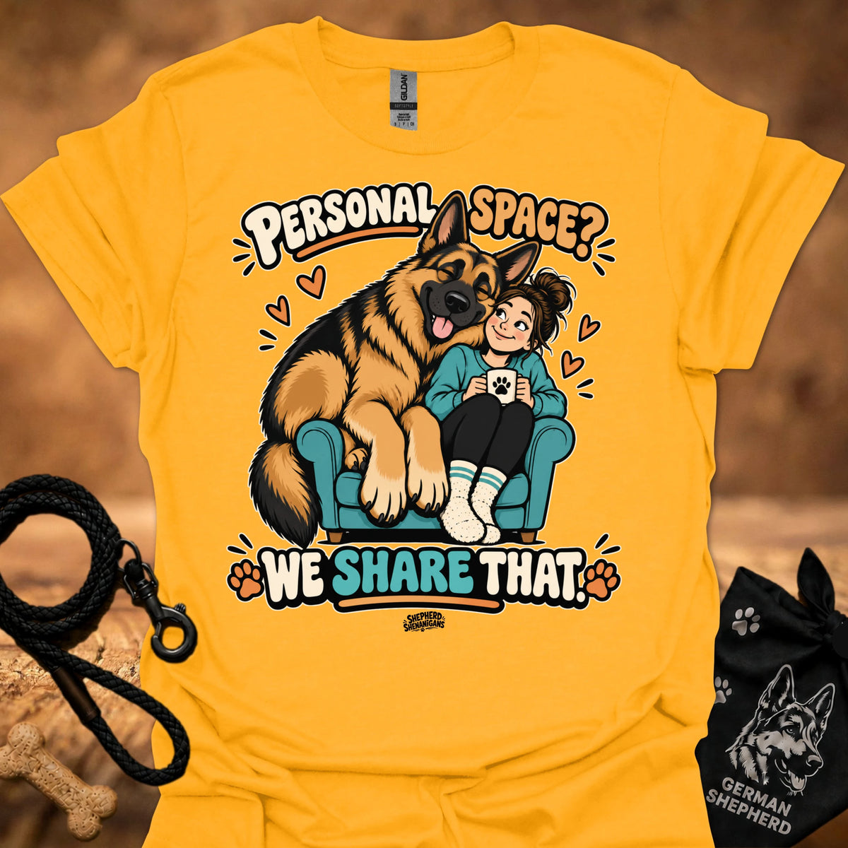 Gold T-shirt with colorful cartoon “Personal Space” graphic featuring a dog and child