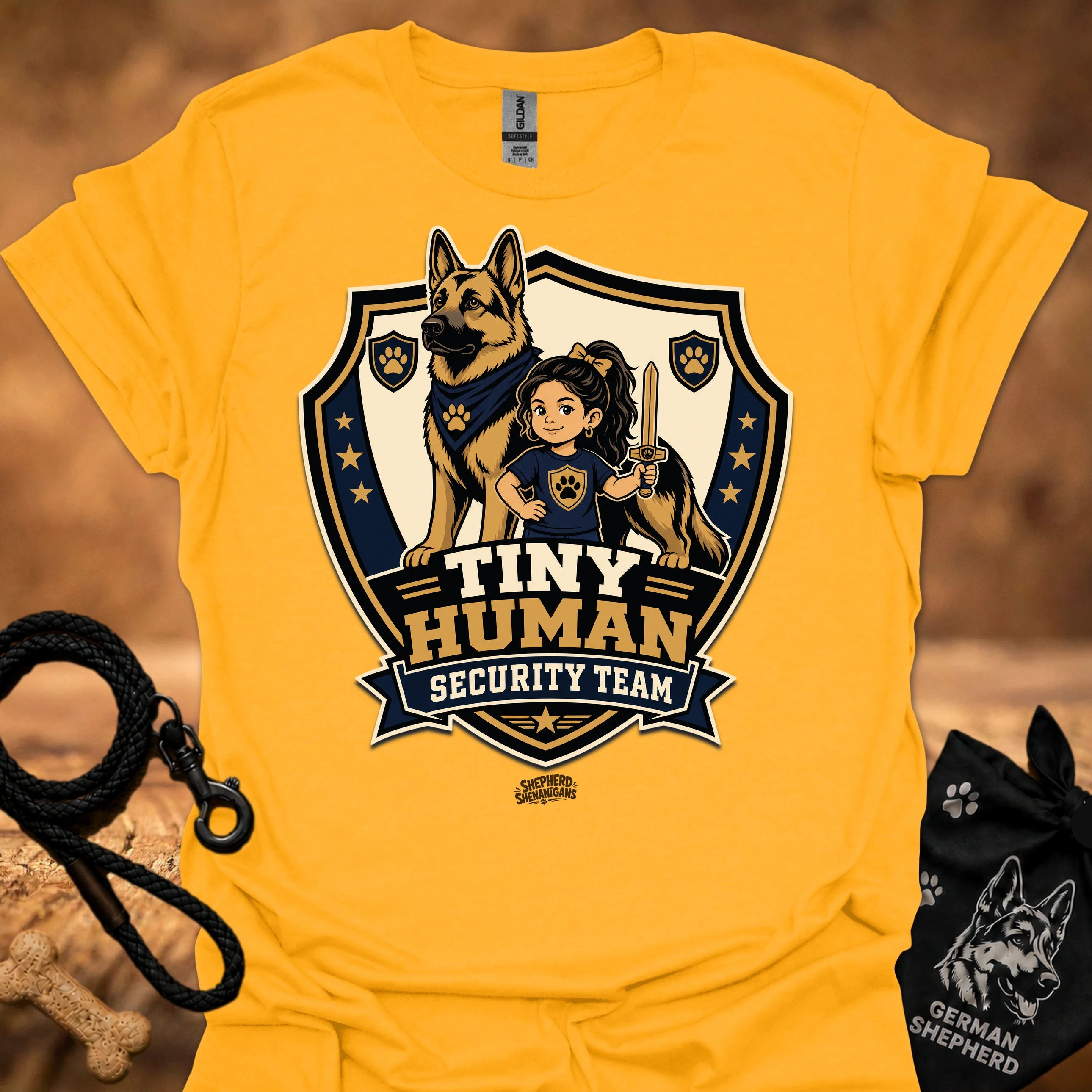 Gold T-shirt with shield mascot graphic and “Tiny Human Security Team” print