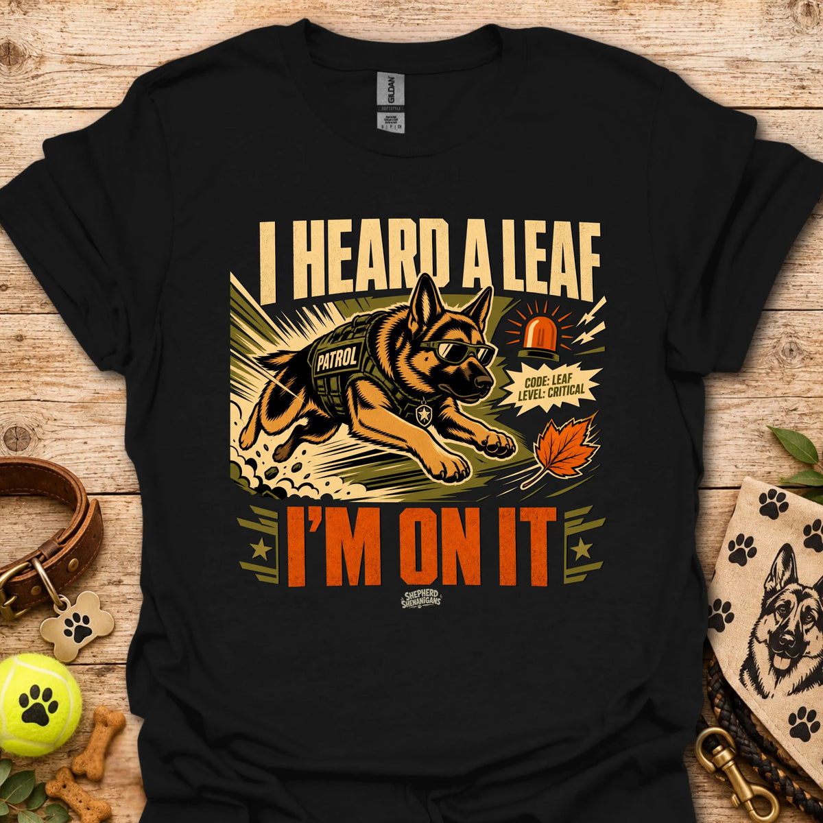 Black t-shirt with dog leaf graphic and bold 'I HEARD A LEAF'/'I'M ON IT' text.