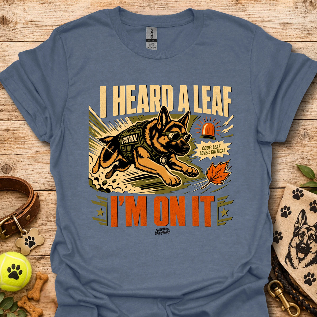 Blue t-shirt with dog leaf graphic and bold 'I HEARD A LEAF'/'I'M ON IT' text.