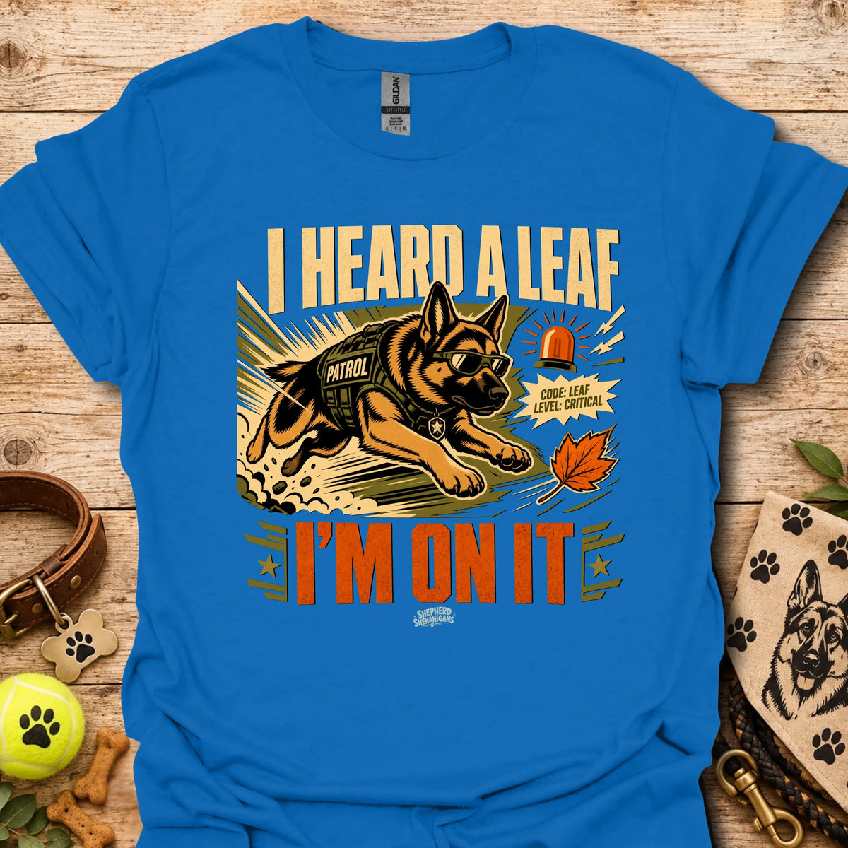 Bright blue t-shirt with dog leaf graphic and bold 'I HEARD A LEAF'/'I'M ON IT' text.