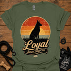 Olive green dog silhouette graphic T-shirt with vintage-style badge emblem