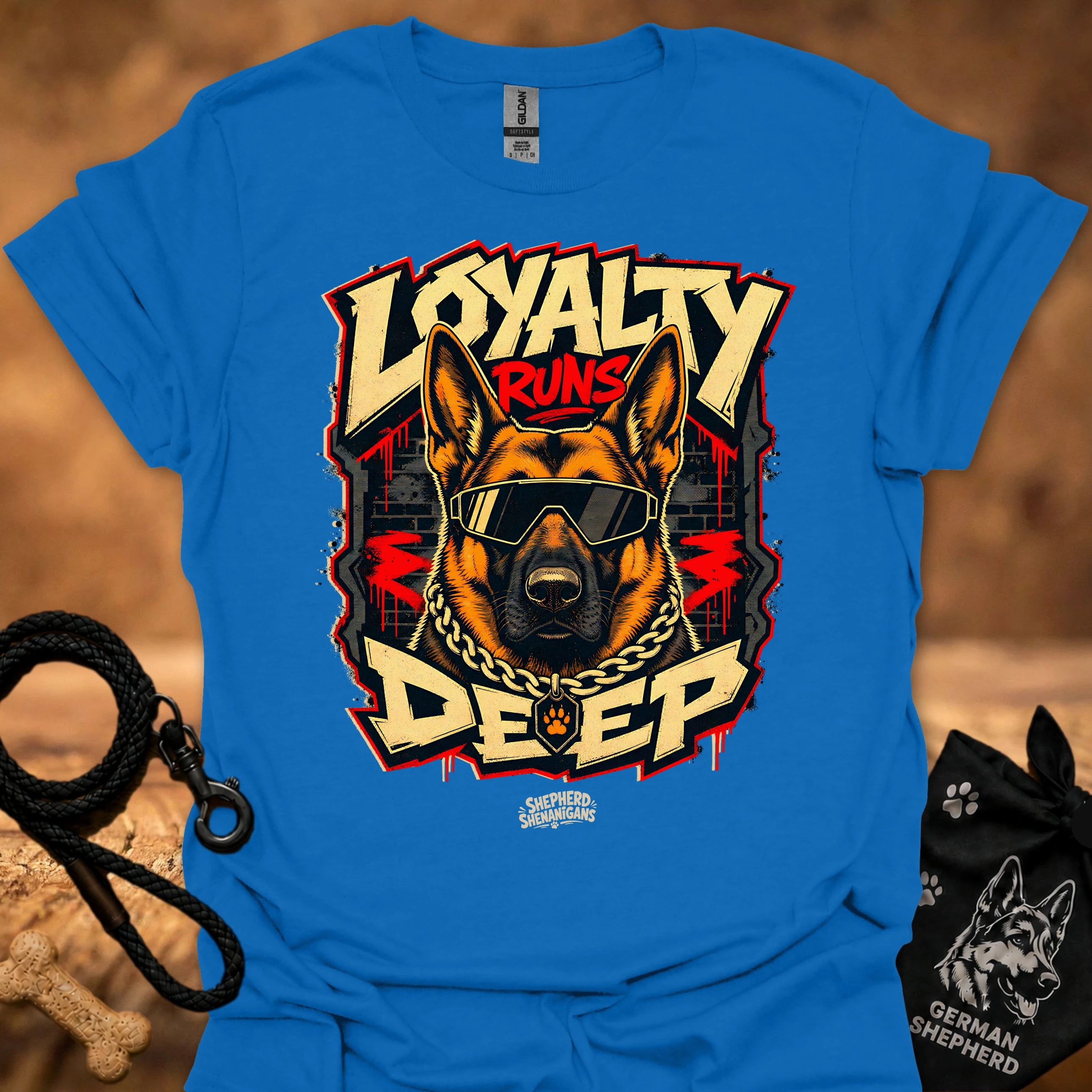 Royal blue t-shirt with German shepherd wearing goggles, chain necklace, and red accent text