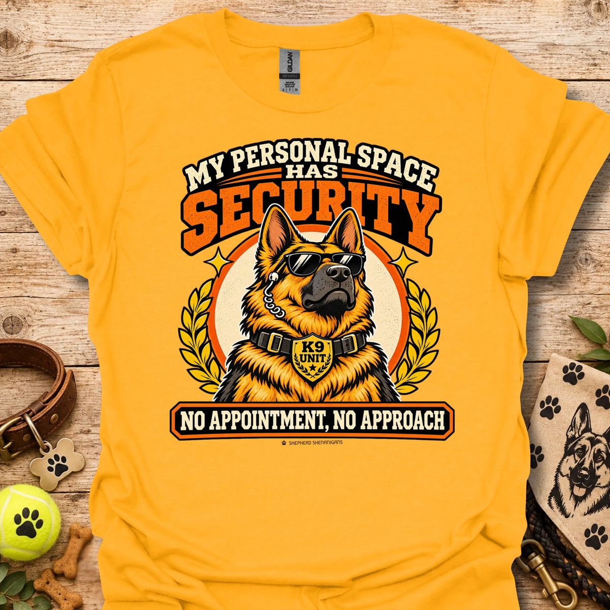 Gold T-shirt featuring a sunglasses-wearing German shepherd and bold security-themed lettering.