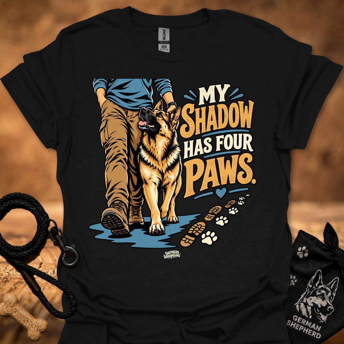 Black T-shirt with dog graphic and “My Shadow Has Four Paws” text