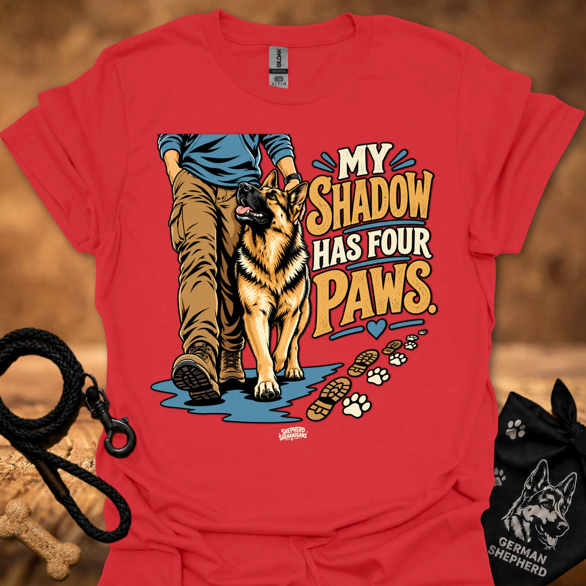 Red T-shirt with dog graphic and “My Shadow Has Four Paws” text