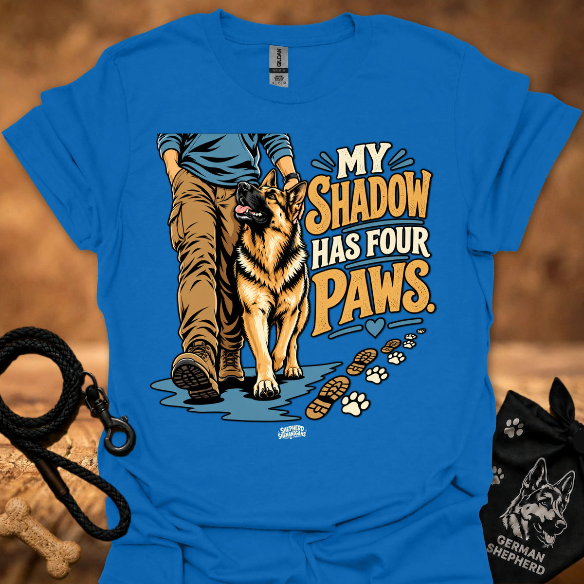 Blue T-shirt with dog graphic and “My Shadow Has Four Paws” text