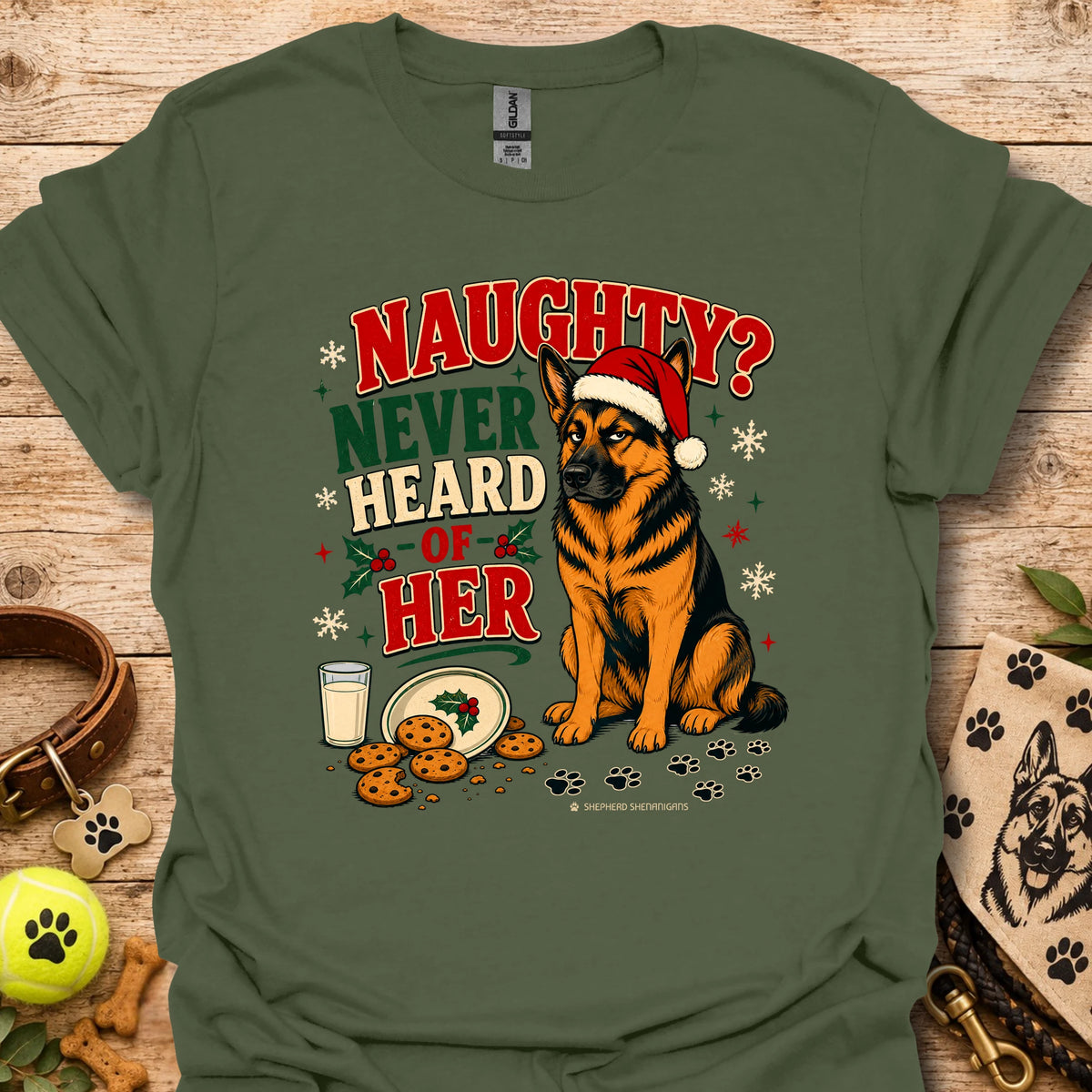 Military green graphic t-shirt with dog in Santa hat and 'Naughty? Never Heard of Her'