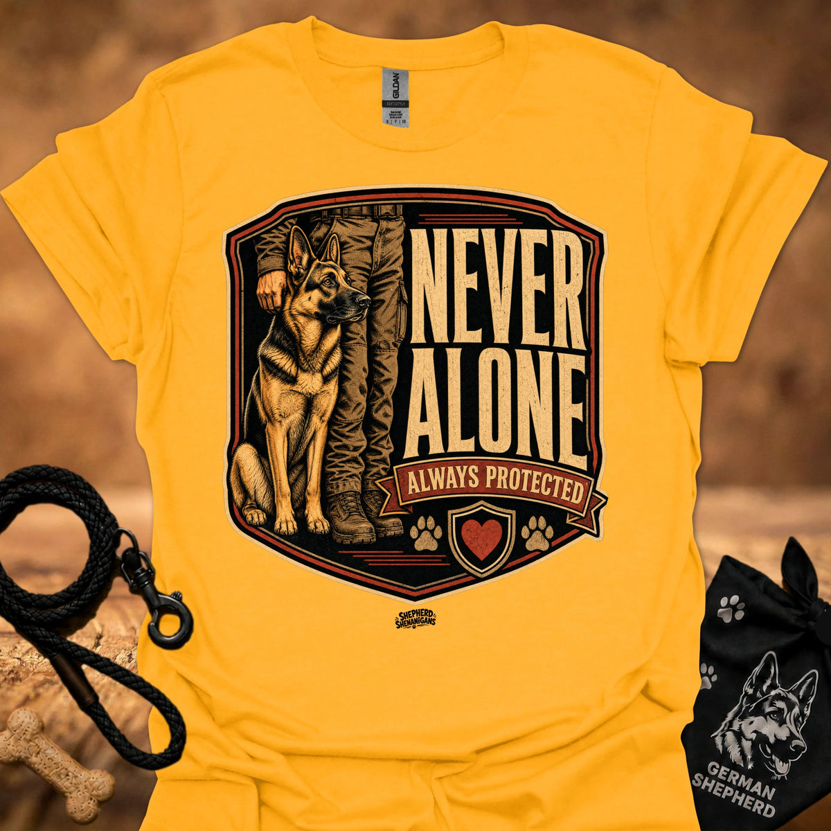 Gold crew-neck T-shirt with German Shepherd crest graphic and "Never Alone" text