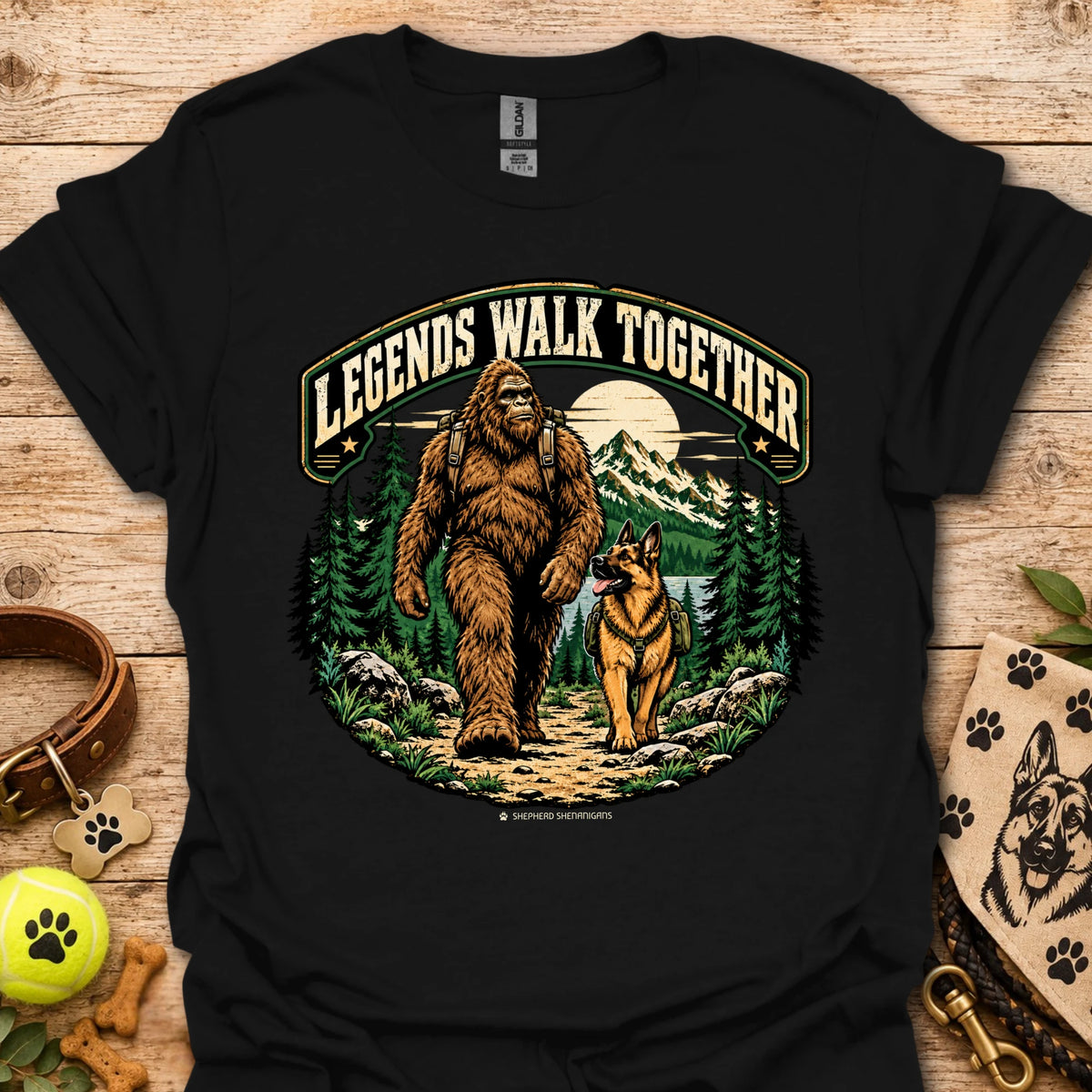Black T-shirt with circular graphic of a bear and dog in forest scene