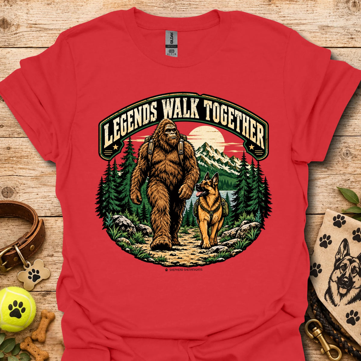 Red T-shirt with circular bear and dog graphic in a forest clearing