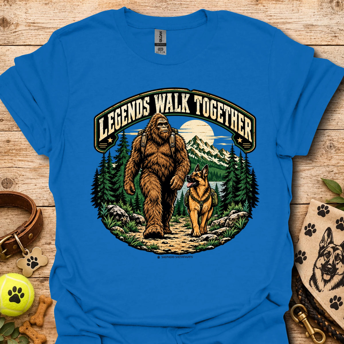 Royal blue T-shirt with circular bear and dog graphic in a forest