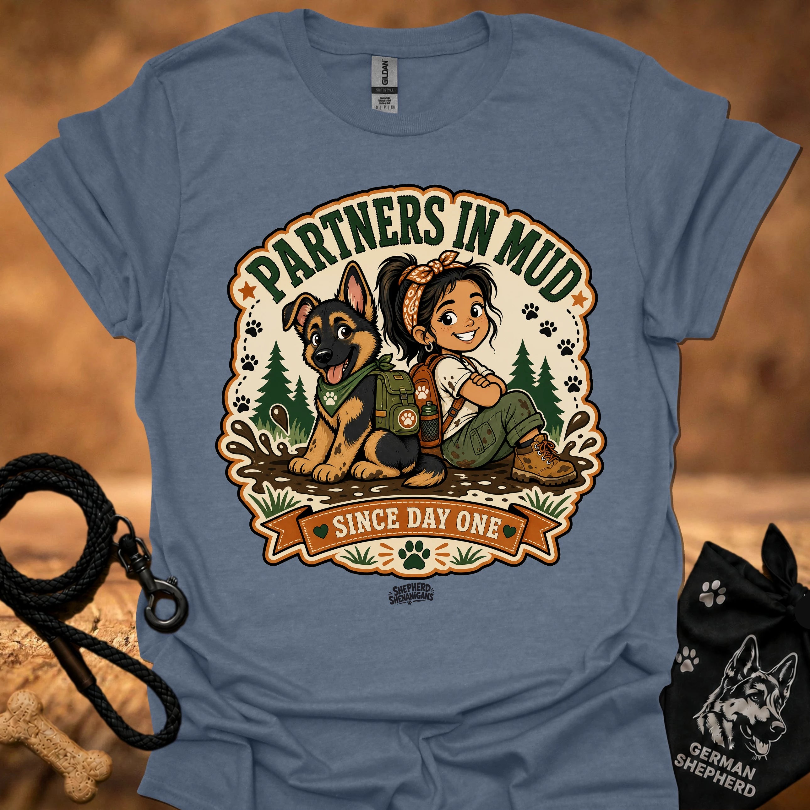 Heather blue women’s t-shirt with “Partners in Mud” dog and girl graphic badge