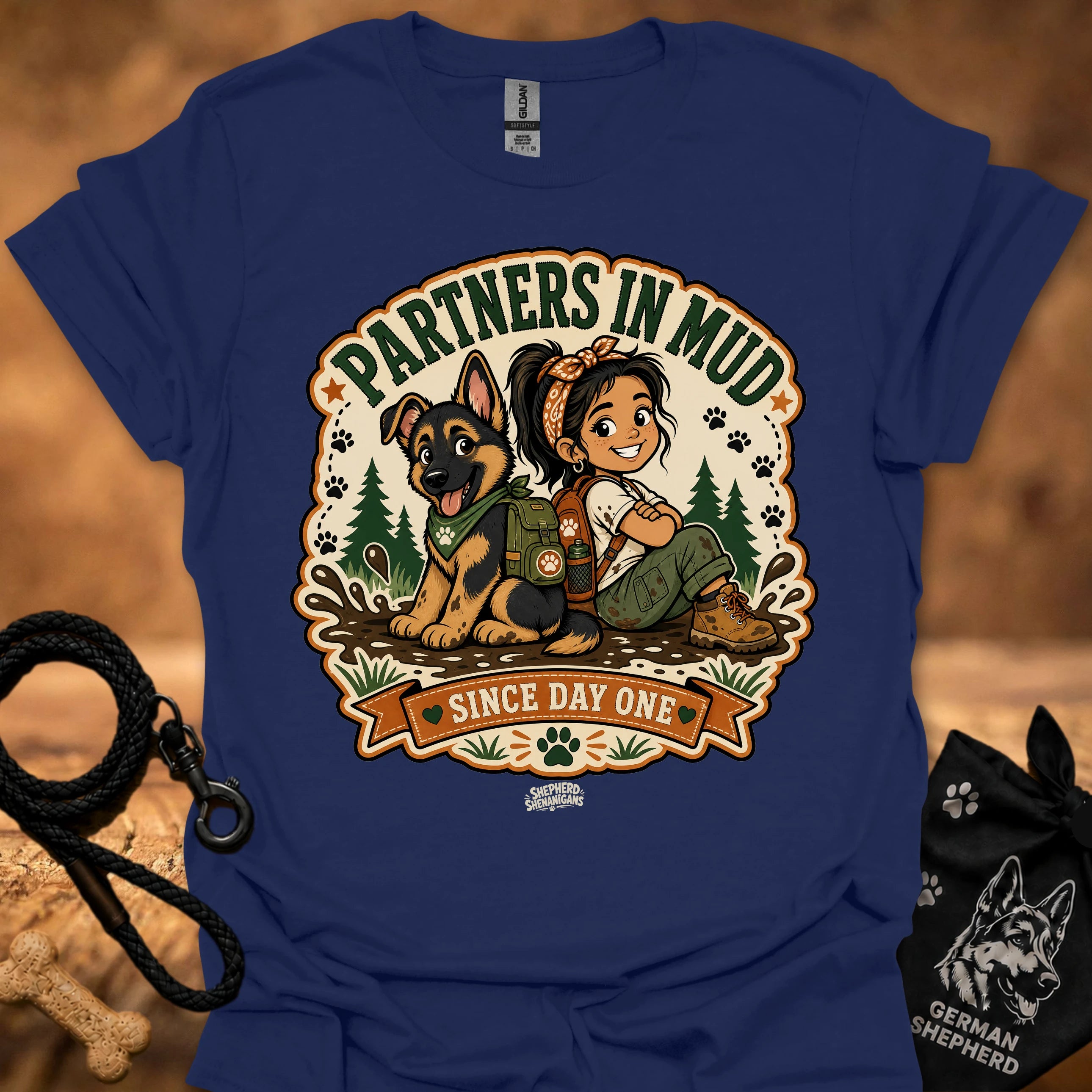 Navy women’s t-shirt with “Partners in Mud” dog and girl “Since Day One” graphic