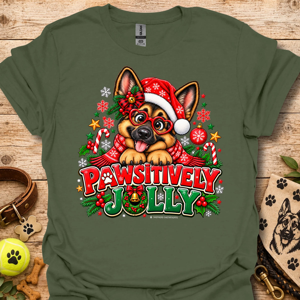Military green T-shirt with festive dog in Santa hat graphic and "Pawsitively Jolly" text
