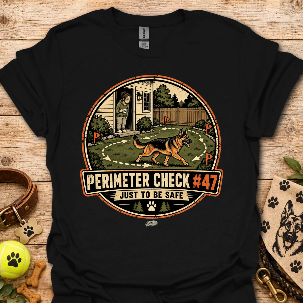 Black T-shirt with circular perimeter check graphic showing a dog and “Just to be safe”