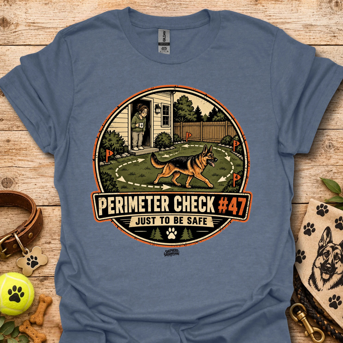Slate blue T-shirt with circular perimeter check graphic showing a dog and “Just to be safe”