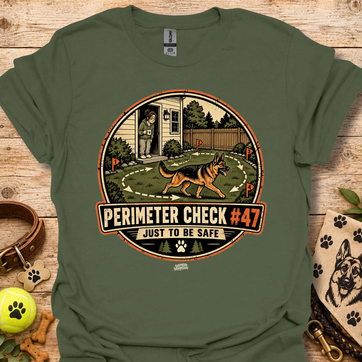 Military green T-shirt with circular perimeter check graphic showing a dog and “Just to be safe”