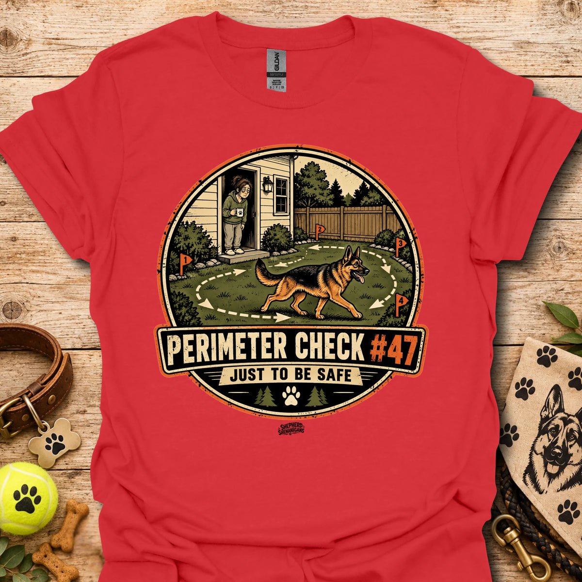 Red T-shirt with circular perimeter check graphic showing a dog and “Just to be safe”