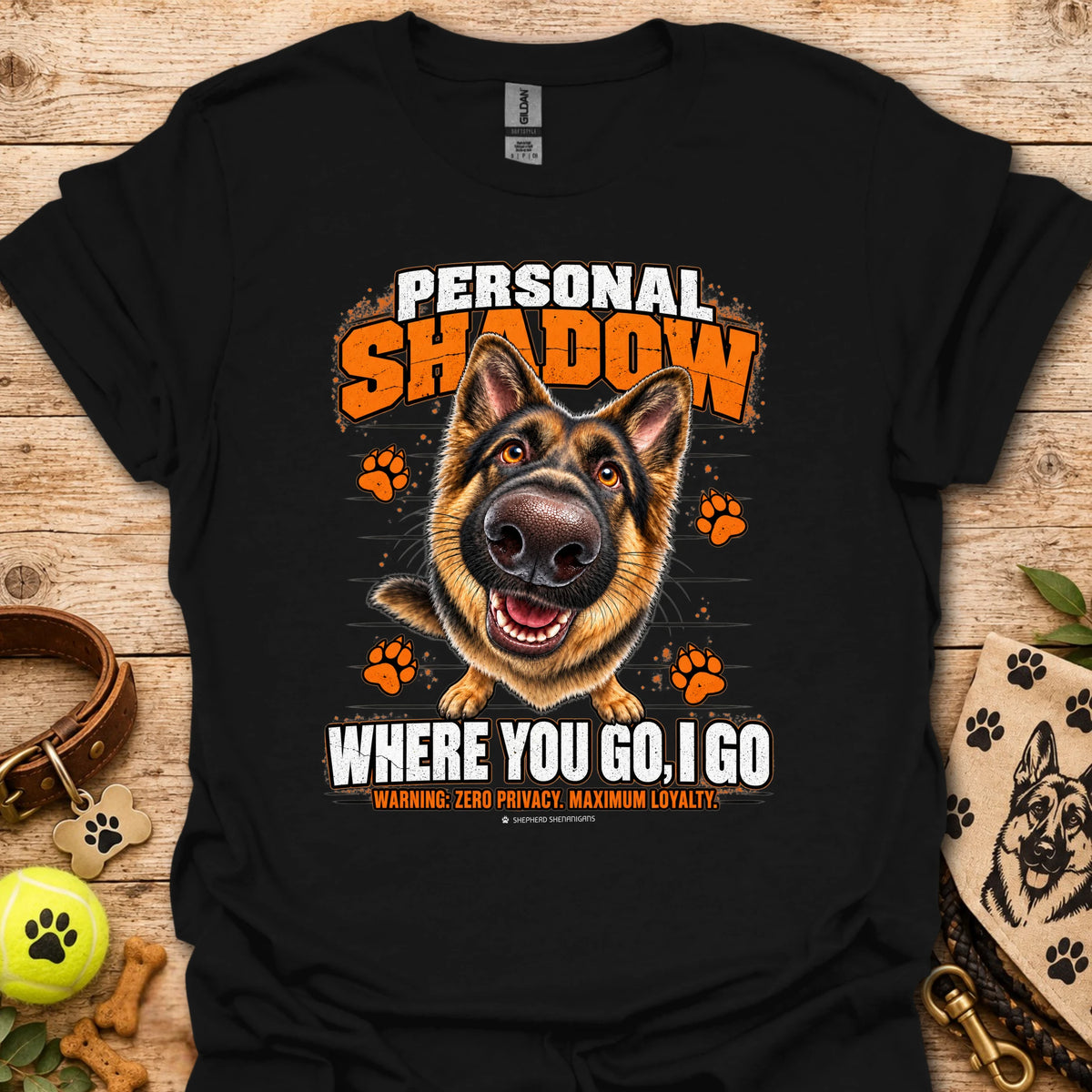 Black T-shirt with a German shepherd graphic, orange paw prints and bold slogan